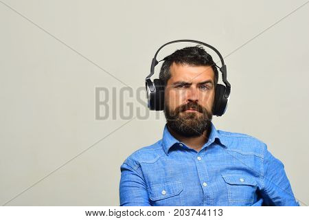 Guy With Beard And Concerned Face Listens To Music