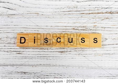 DISCUSS word made with wooden blocks concept