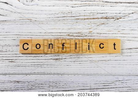 CONFLICT word made with wooden blocks concept