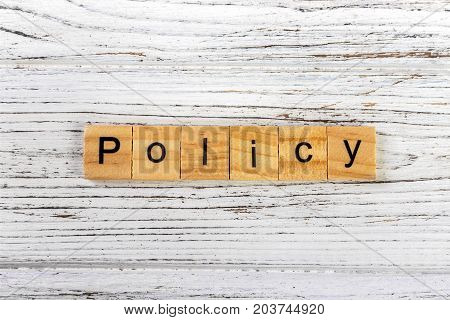 Policy word made with wooden blocks concept