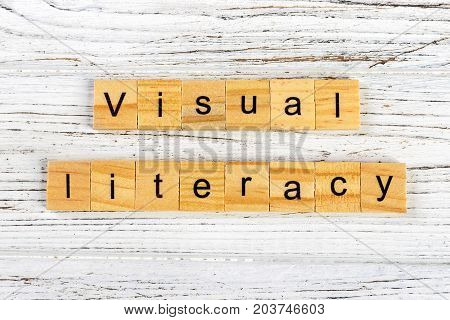 visual literacy word made with wooden blocks concept
