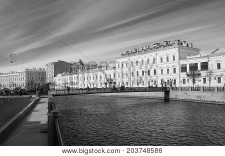 A walk along the embankment of the Moika River in St. Petersburg the Pochtamtsky Bridge