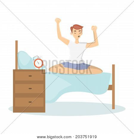 Man waking up. Young sleepy man sits on bed stretching arms.