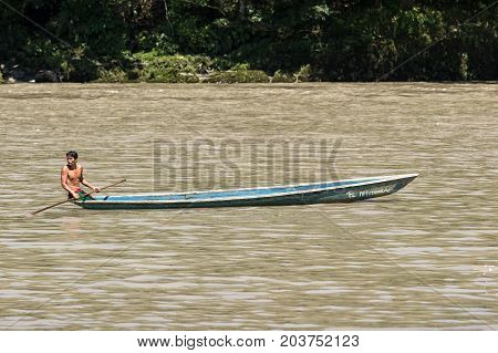 June 6 2017 Misahualli Ecuador: indigenous man in canoe on the Napo river in the Amazon area