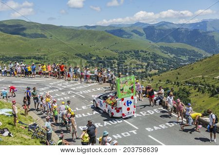 Col de PeyresourdeFrance- July 23 2014: Carrefour vehicle passing in the Publicity Caravn on the road to Col de Peyresourde in Pyrenees Mountains during the stage 17 of Le Tour de France 2014.