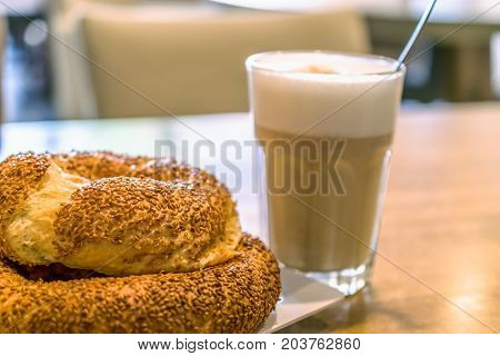 Turkish traditional sesame bagels. Simit and latte macchiato in the cafe