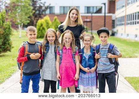 The Great Portrait Of School Pupil Outside Classroom Carrying Bags