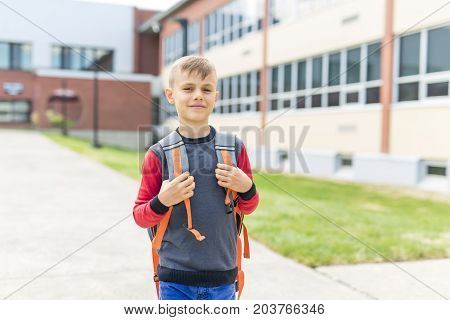 The Great Portrait Of School Pupil Outside Classroom Carrying Bags