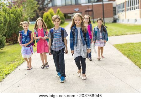 The Great Portrait Of School Pupil Outside Classroom Carrying Bags