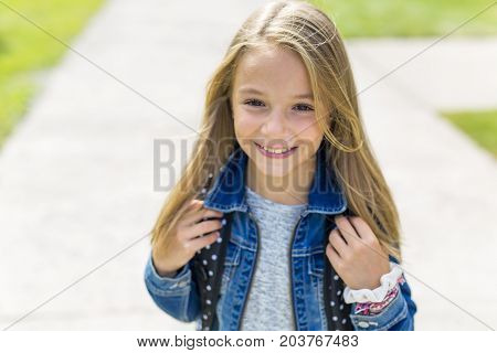 The Great Portrait Of School Pupil Outside Classroom Carrying Bags