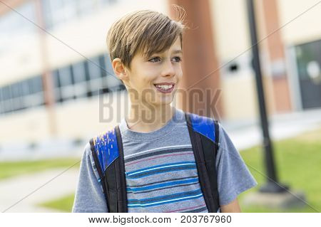 The Great Portrait Of School Pupil Outside Classroom Carrying Bags