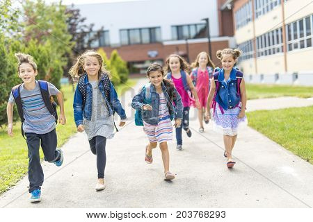 The Great Portrait Of School Pupil Outside Classroom Carrying Bags