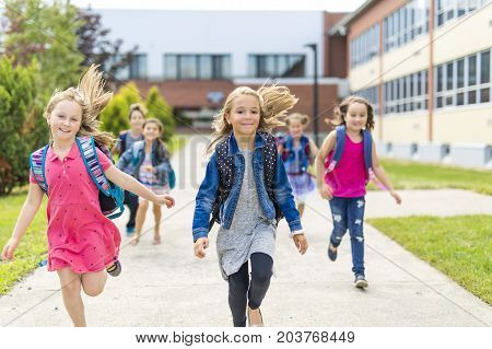 The Great Portrait Of School Pupil Outside Classroom Carrying Bags