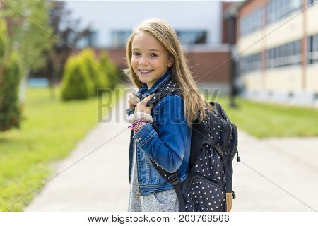 The Great Portrait Of School Pupil Outside Classroom Carrying Bags