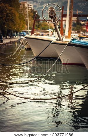 Marine port with moored yachts and boats in sea during sunset