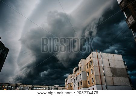 Storm clouds a hurricane is coming. Beautiful storm sky with clouds over the city apocalypse like