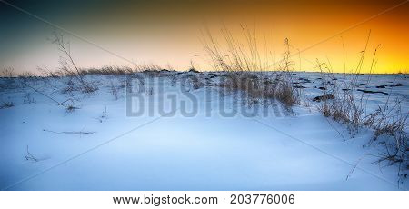 Beautiful winter landscape. Sunset over winter snow fields