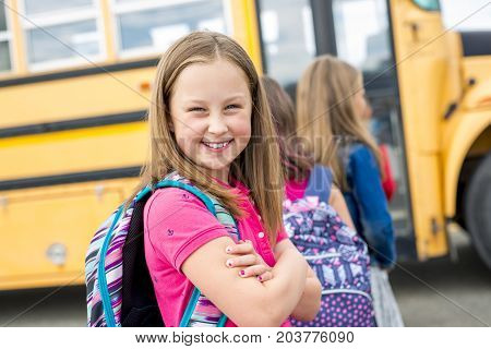 The Great Portrait Of School Pupil Outside Classroom Carrying Bags