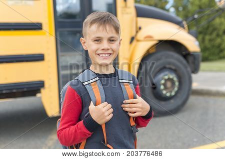 The Great Portrait Of School Pupil Outside Classroom Carrying Bags
