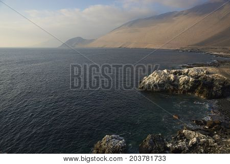 White guano covered cliffs along the Pacific coast of northern Chile.