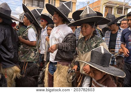 June 25 2017 Cotacachi Ecuador: kechwa indigenous men participating at the Inti Raymi parade by stomping in a tight formation