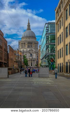 London UK - August 3 2017: Looking towards St. Paul's Cathedral from the Millennium Bridge. Shows crowds of tourists moving between St. Pauls and the Millennium Bridge.