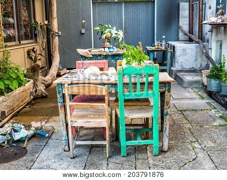 TOKYO, JAPAN JUNE 28 - 2017: Outdoor view of old table and chairs in a restaurant at Komachi-dori Street, in Kamakura in Tokyo Japan.