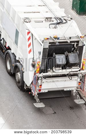 Modern white garbage dustcart truck on city street. Recycling in town concept.