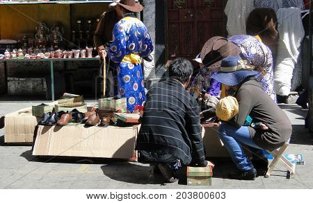 People Walk Around Jokhang Temple In Tibet