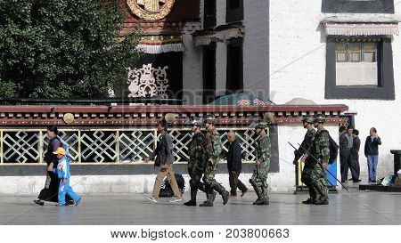 Chinese Soldiers Walking At The Jokhang Temple