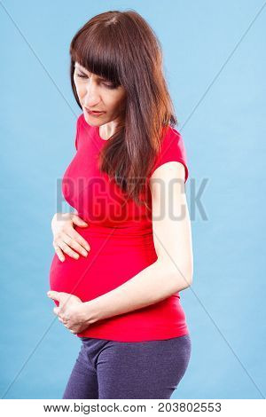 Sad Woman In Pregnant With Stomach Pain Touching Her Belly, Concept Of Aches In Pregnancy And Risk O