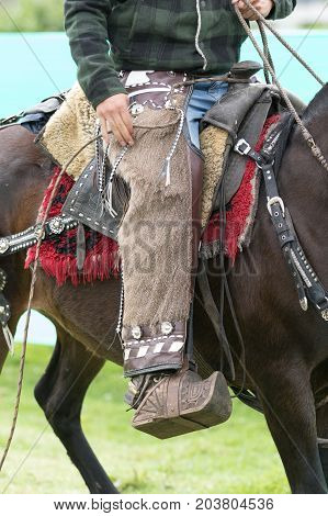 June 3 2017 Machachi Ecuador: traditional chaps detail worn by a cowboy on horseback