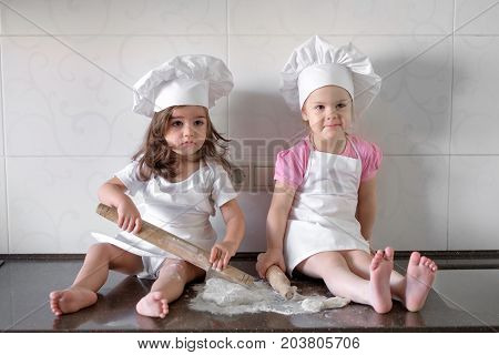 happy family funny kids are preparing the dough, bake cookies in the kitchen.