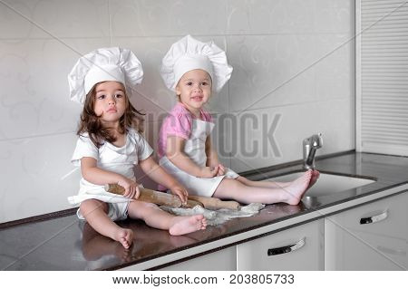 happy family funny kids are preparing the dough, bake cookies in the kitchen.