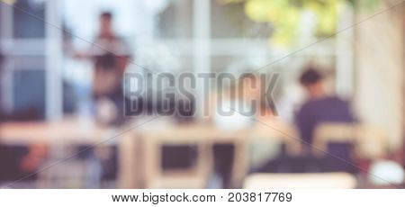 Blurred background : blur group of people team meeting at co-working space casual style teamwork concept business education concept