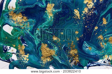 Marbled abstract background. Liquid marble pattern. Colorful marble backdrop. Golden glitter texture