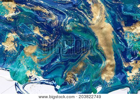 Marbled abstract background. Liquid marble pattern. Colorful marble backdrop. Golden glitter texture