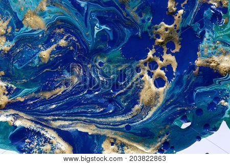Marbled abstract background. Liquid marble pattern. Colorful marble backdrop. Golden glitter texture