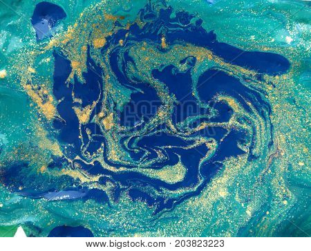 Marbled abstract background. Liquid marble pattern. Colorful marble backdrop. Golden glitter texture