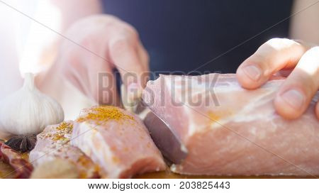 A man cuts meat. Pork, chops. cooking