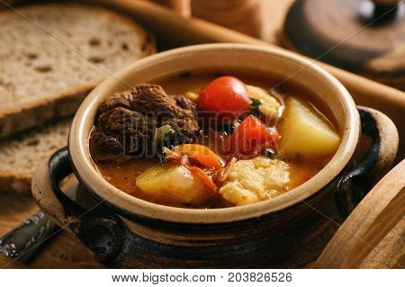 Hungarian soup goulash (bograch) with dumplings .