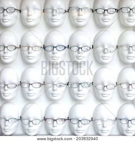 plastic faces in a row with glasses