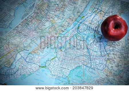 An apple  pictured with a map of New York City, New York.