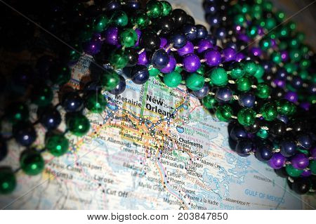 Macro Gras beads pictured with a map of New Orleans, Louisiana.