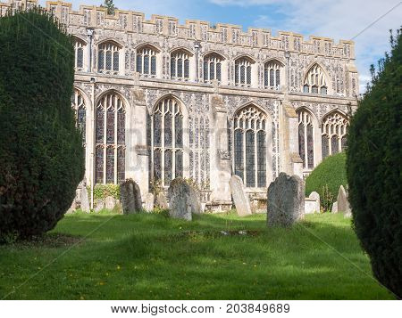 View Of Glasses Ornate Side Of Church Hall, With Graves In Front