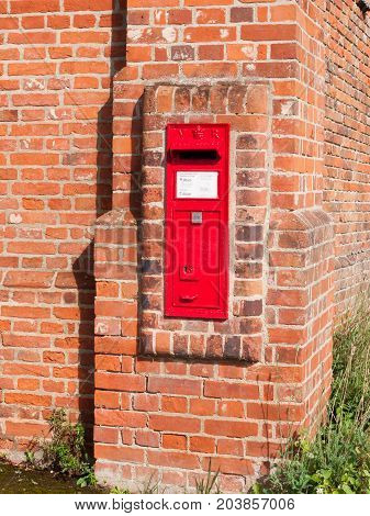 Close Up Of Red Royal Mail Box In Brick Wall Postage