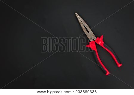 Must have at home used hand tools Needle Nose Pliers on black background with copy space