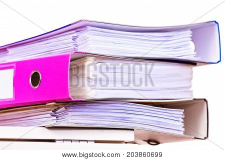 Paperwork. Stack of file folders ring binders on office table dask.