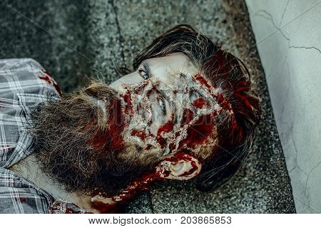 Halloween Zombie Lying On Paving Asphalt