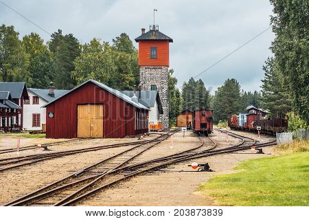 Old train station with several tracks shifts and a loading tower. Located in a small town on the Swedish countryside
